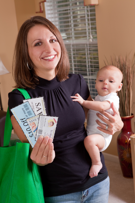 Smiling Mother Holding Baby And Coupons